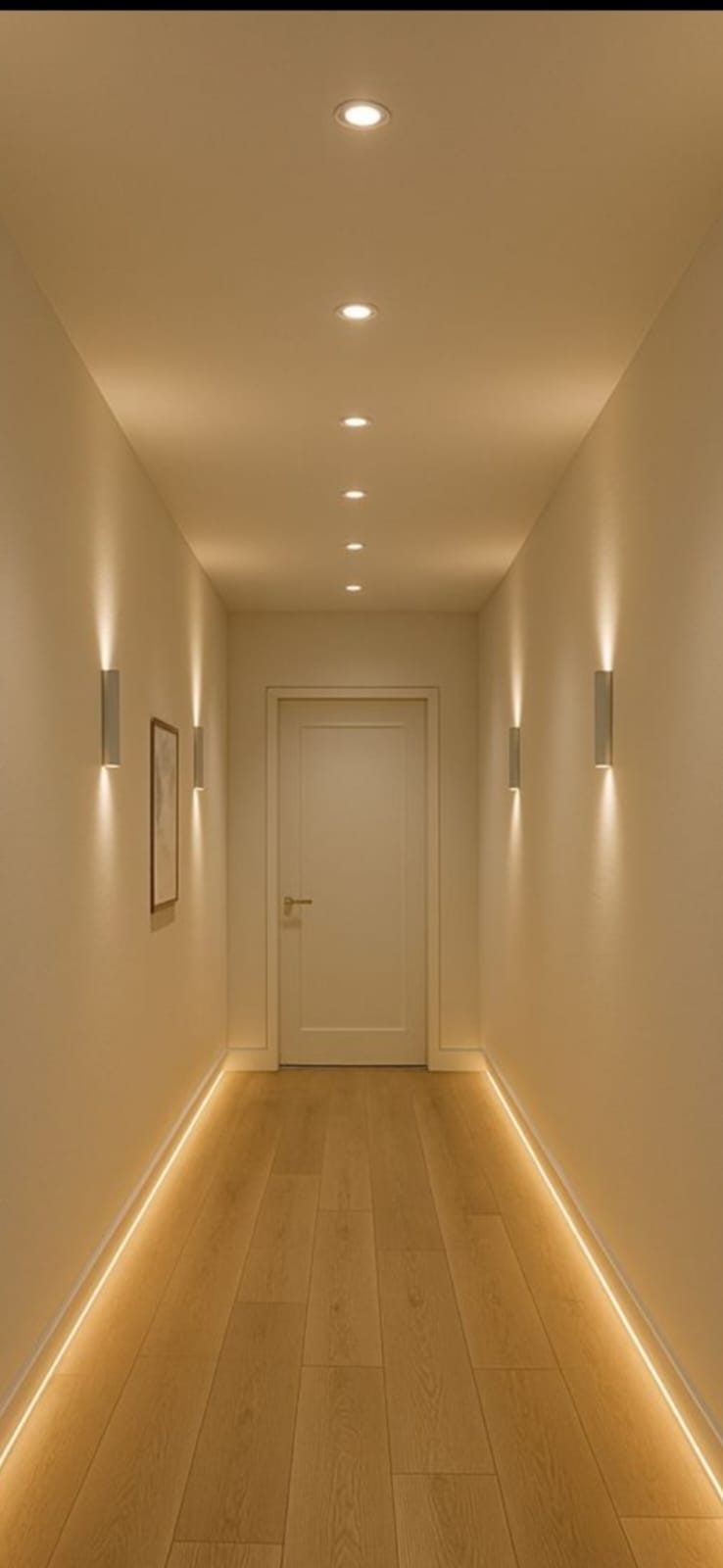Hallway with warm concealed LED cove lighting running along the floor and walls